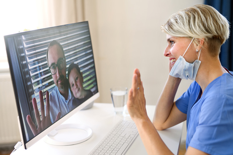 Female doctor having video call with patients during telehealth session